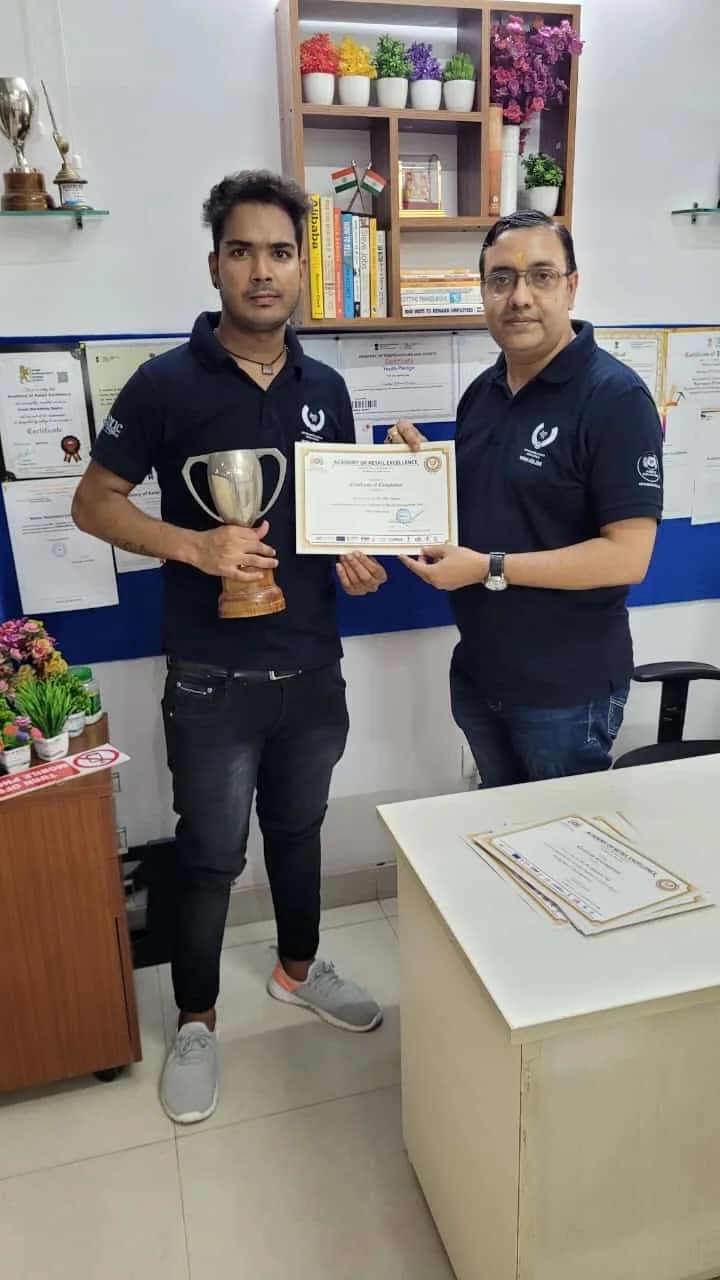An Academy of Retail Excellence certificate being handed to a student