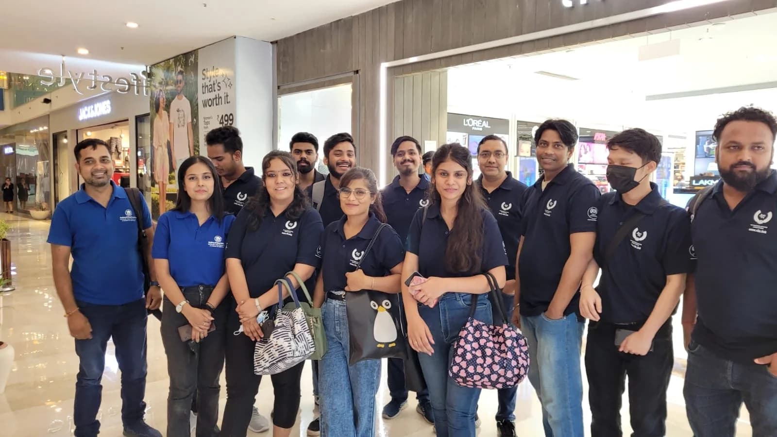 A group of Academy of Retail Excellence students photographed together. Sign visible in the photograph: Lifestyle · Jack & Jones · L’Oréal.